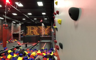 Rock climbing wall with foam pit